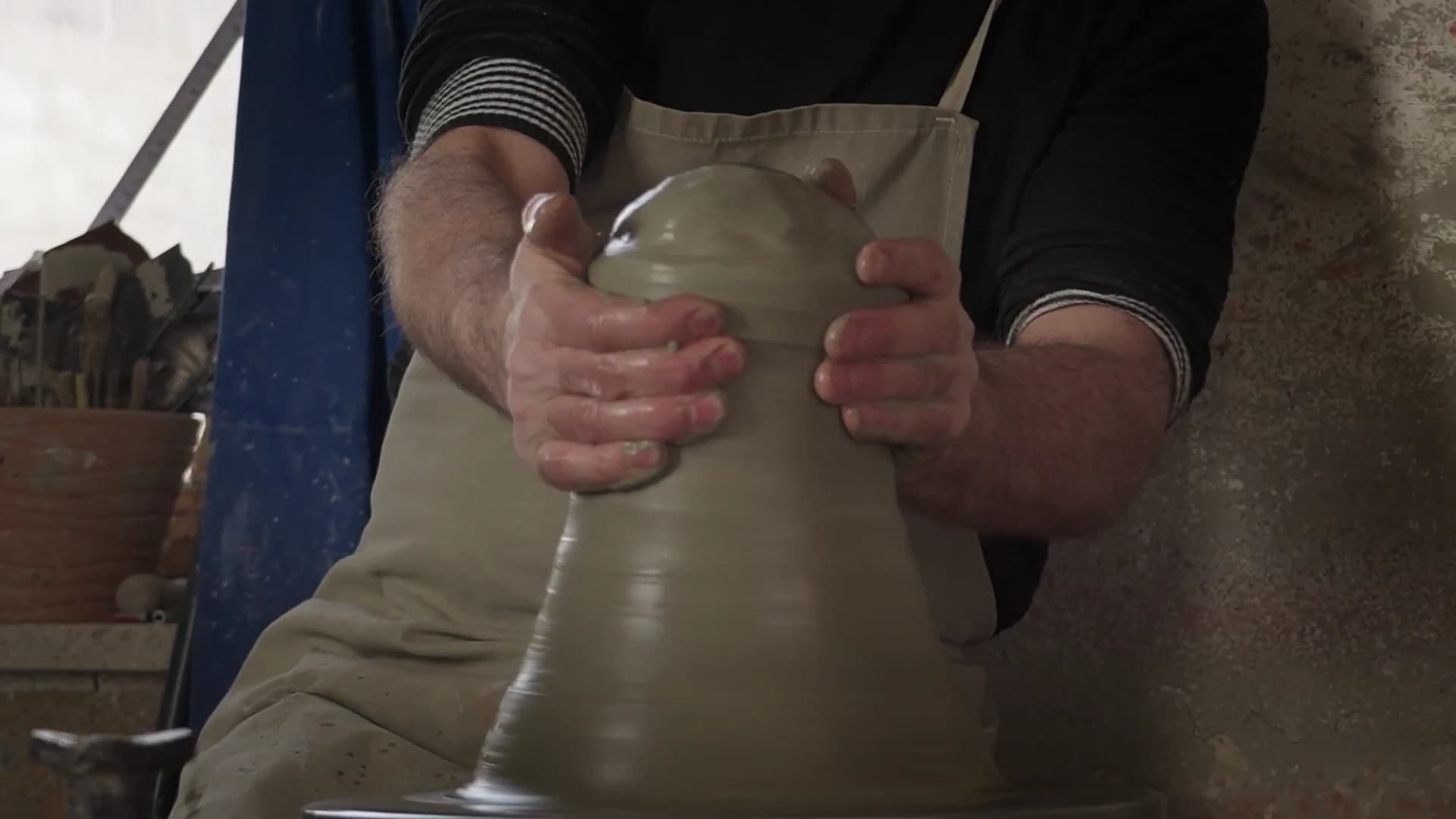 A Terzofoco artisan shaping ceramic by hand